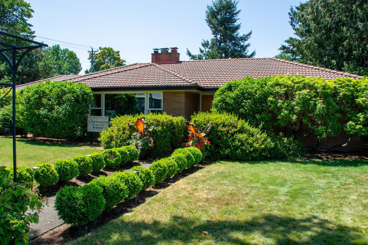 Low ranch style older house with clay tile roof