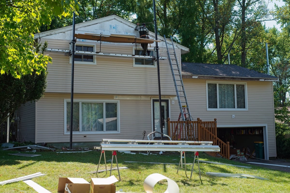 Split level suburban house with new siding, older home exterior