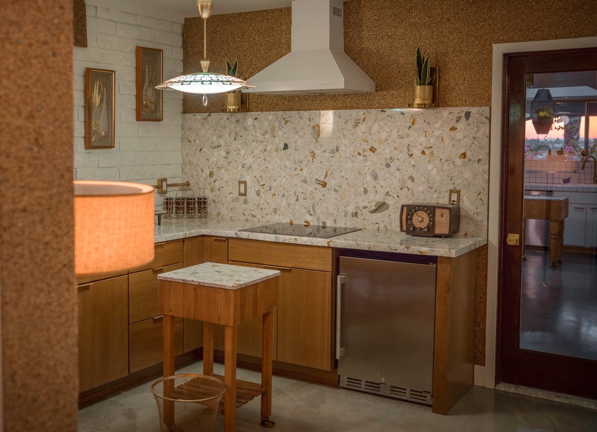 2000s style full kitchen with wood cabinets, granite counters, and vent hood