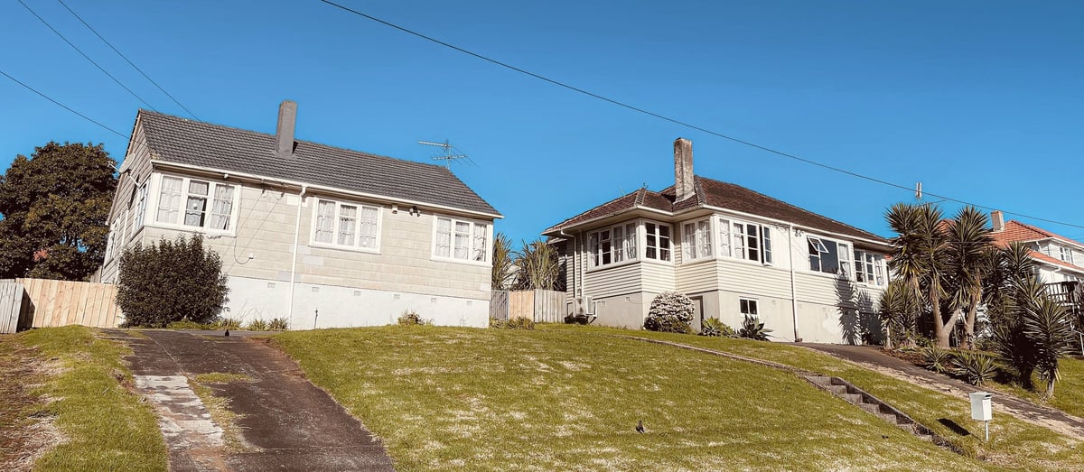 Older house in suburban setting needing cosmetic updates, overgrown grass